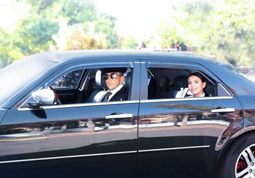 Businesswoman riding a car with chauffeur